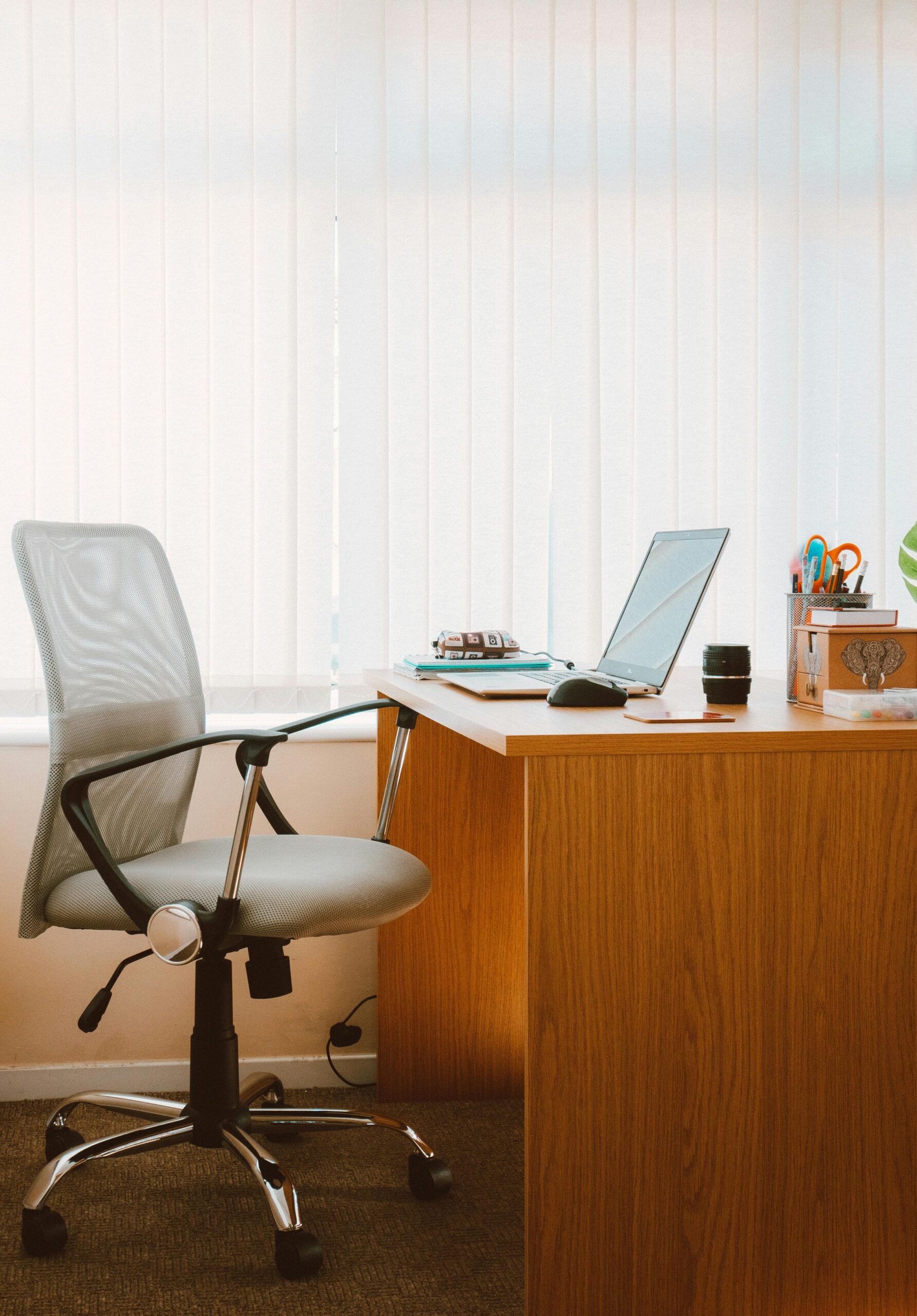 a rolling chair is next to a desk with a laptop on it