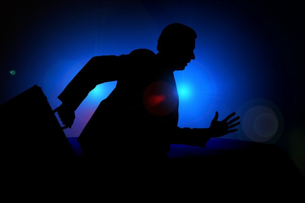 A silhouette of a person running against a dark blue background.
